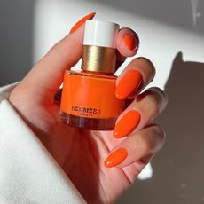 Bright orange manicure with Hermes nail polish