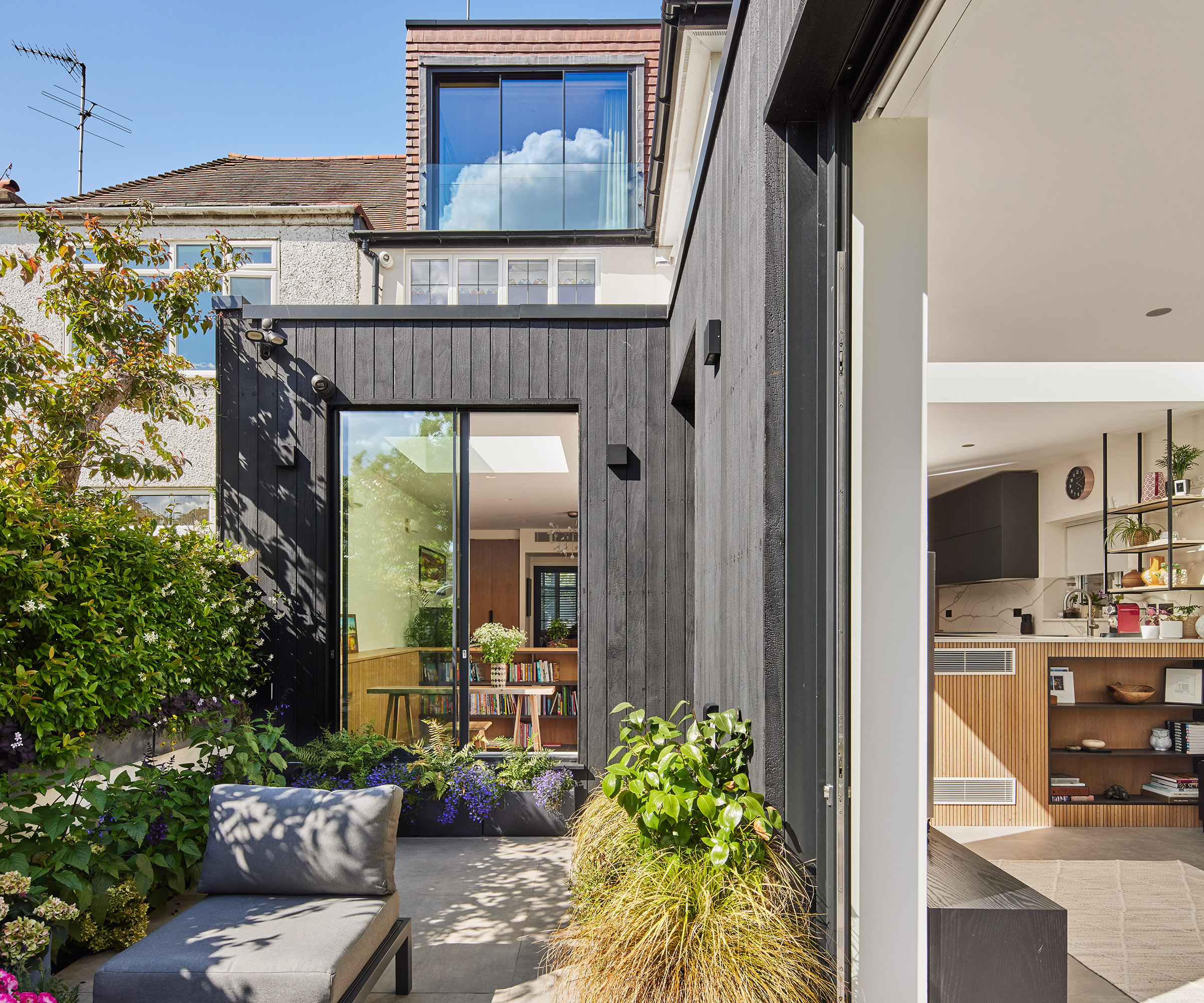 Exterior of a side return with a timber cladding and new glazing