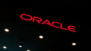 Oracle logo pictured in red lettering against a black background at the company's stall at Mobile World Congress (MWC) 2025 in Barcelona, Spain.