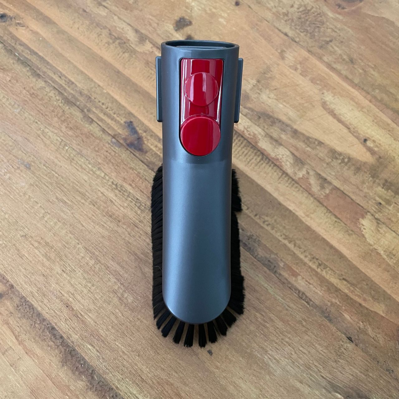 dyson dusting brush on a wooden table