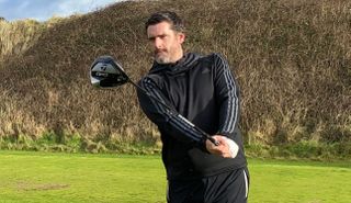 A golfer swings the TaylorMade Qi10 Driver