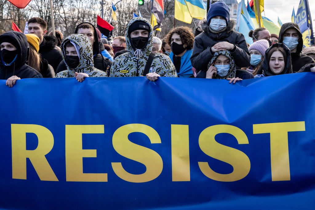 Ukrainian demonstrators carrying a sign that reads &amp;quot;RESIST&amp;quot;