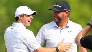 Michael Block (R) of the United States, PGA of America Club Professional, celebrates his hole-in-one on the 15th tee with Rory McIlroy (L) of Northern Ireland during the final round of the 2023 PGA Championship at Oak Hill Country Club