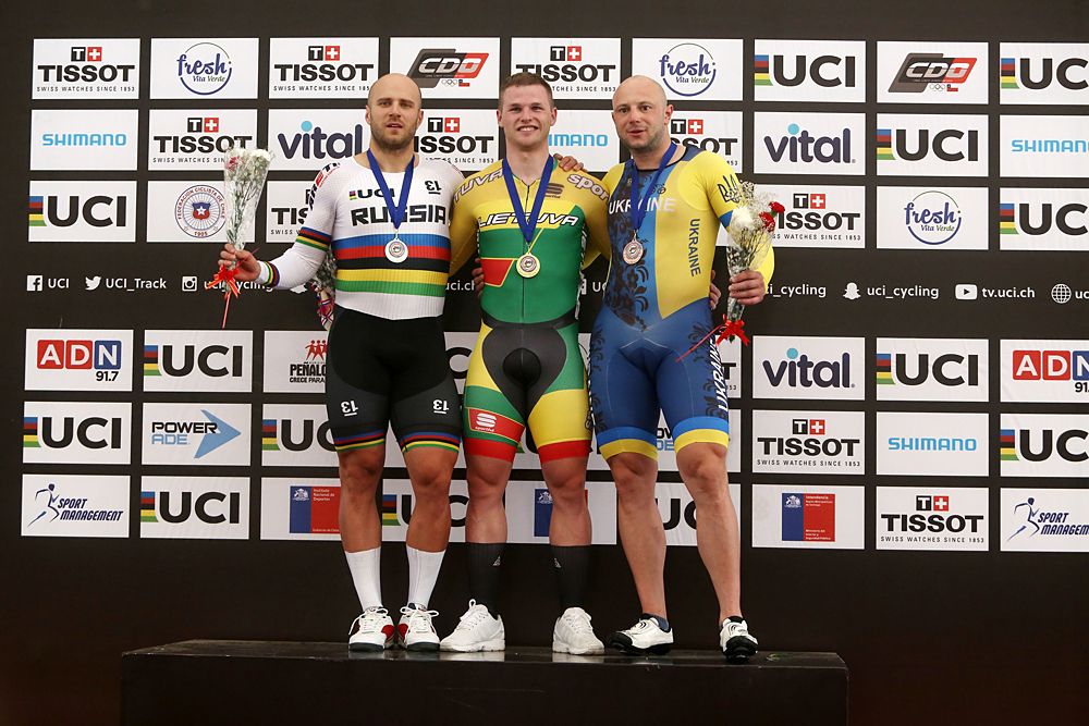 Lithuanian gold medallist Vasilijus Lendel (C), Russian silver medallist Denis Dmitrev (L) and Ukranian bronze medallist Roman Gladysh pose on the podium after winning the men's Sprint final race, during the Tissot UCI Track Cycling World Cup