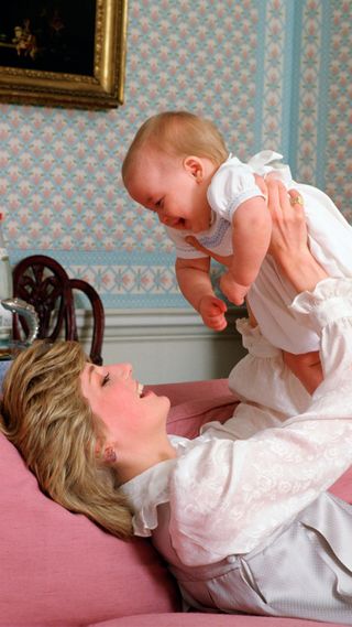 Princess Diana holding a baby Prince William
