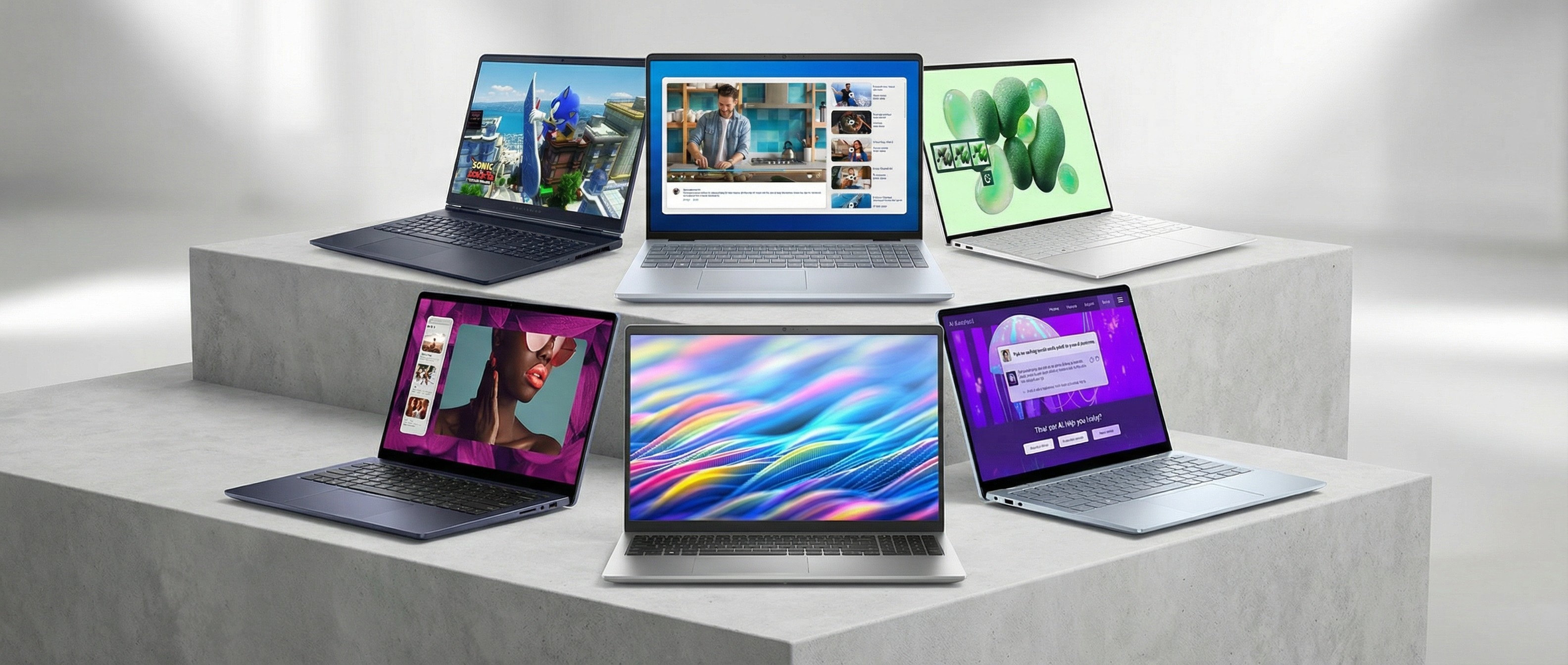 Six Dell laptops presented on a plinth in a white room