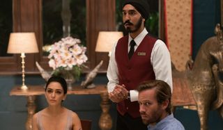 Hotel Mumbai Dev Patel, Nazanin Boniadi, and Armie Hammer look outside of the restaurant in the midd