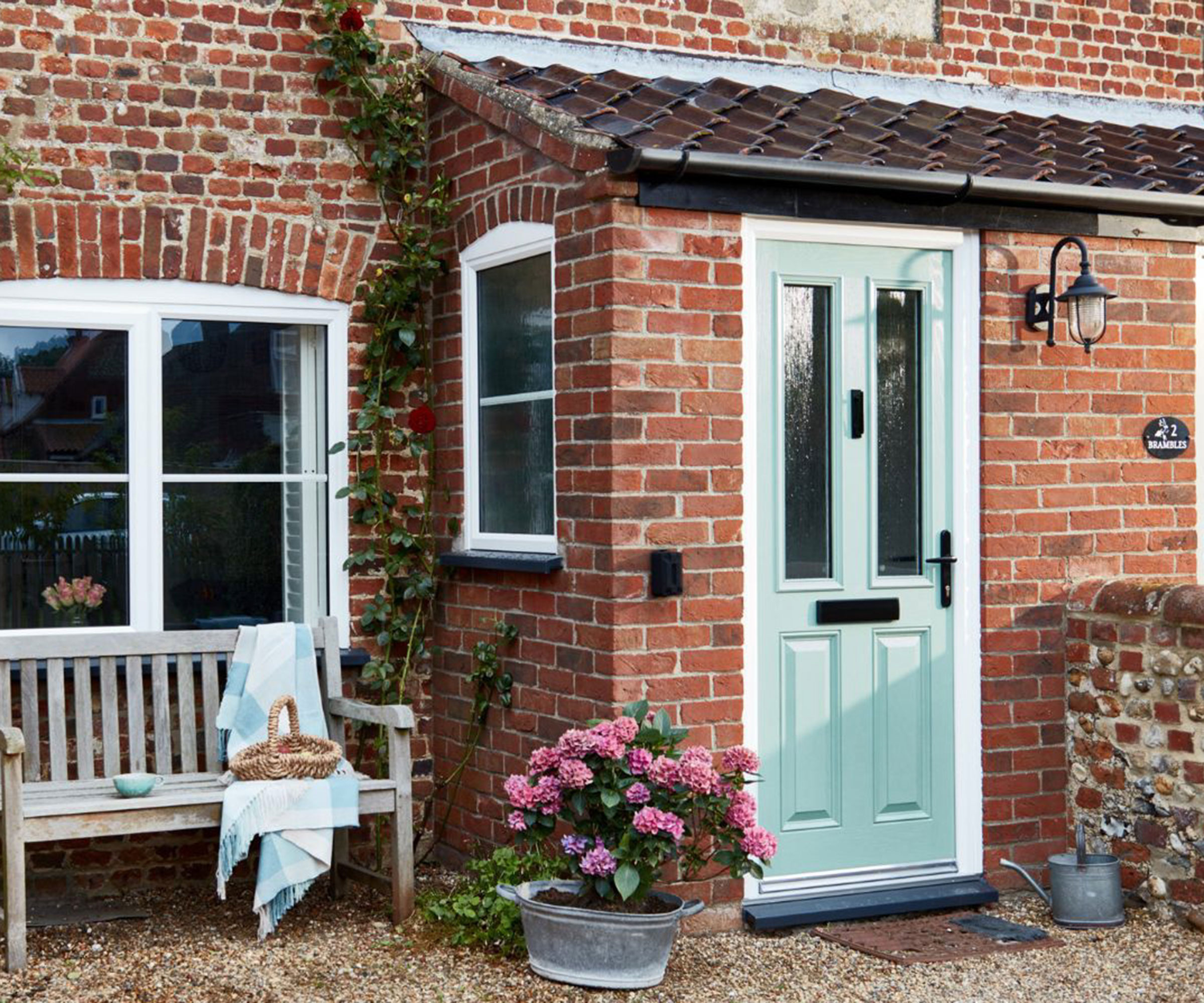 small enclosed porch with pale green front door