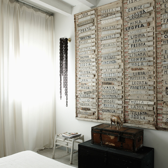 bedroom with white curtain and trunk boxes