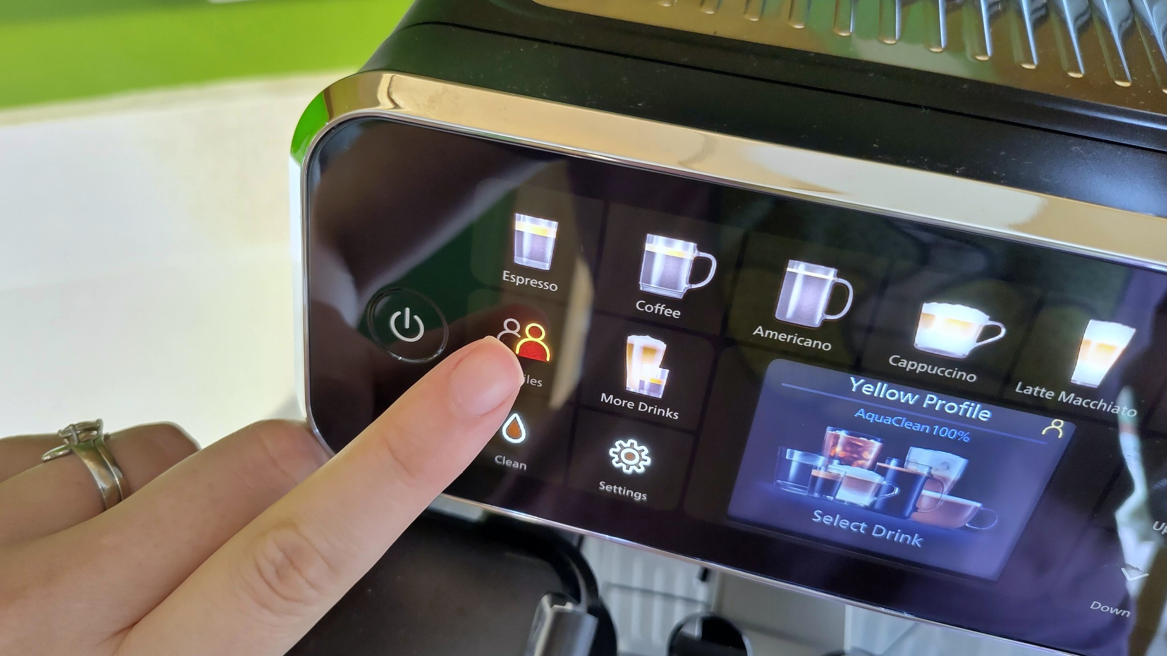 Person selecting user profile on Philips LatteGo 5500 Series coffee maker