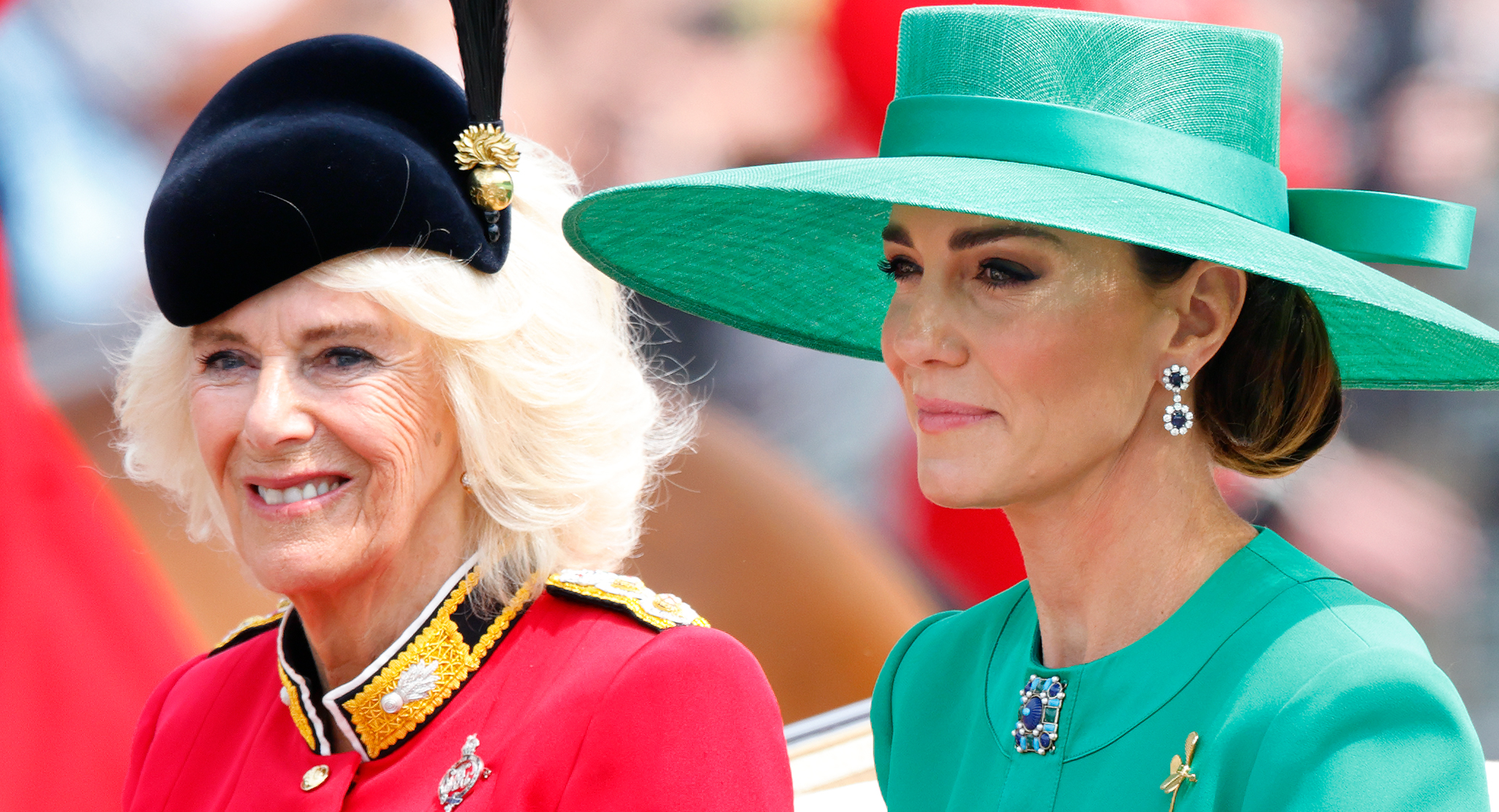 Queen Camilla wears a red uniform while Kate Middleton wears a green dress and matching hat