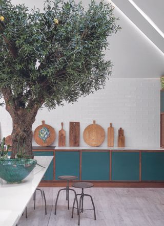 A kitchen with chopping boards leaning against the wall