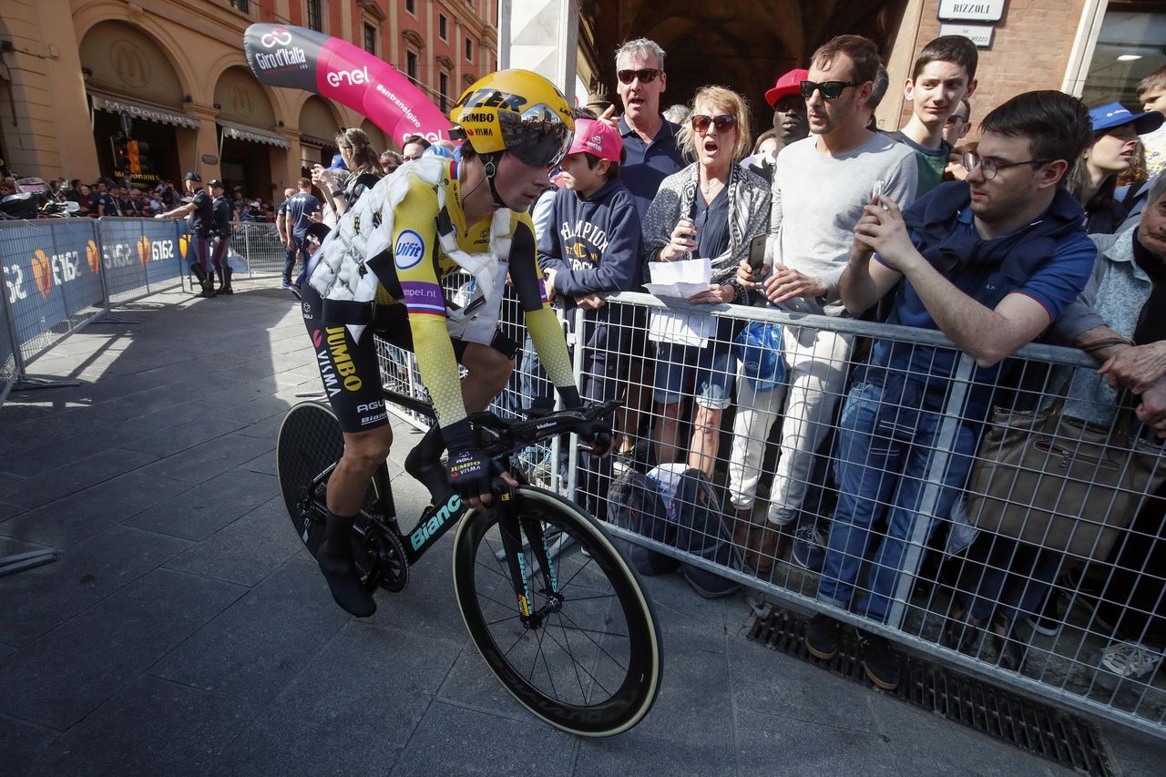 Roglic, wearing a cooling vest, heads to the stage start