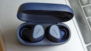 The Jabra Elite 4 wireless earbuds in their charging case