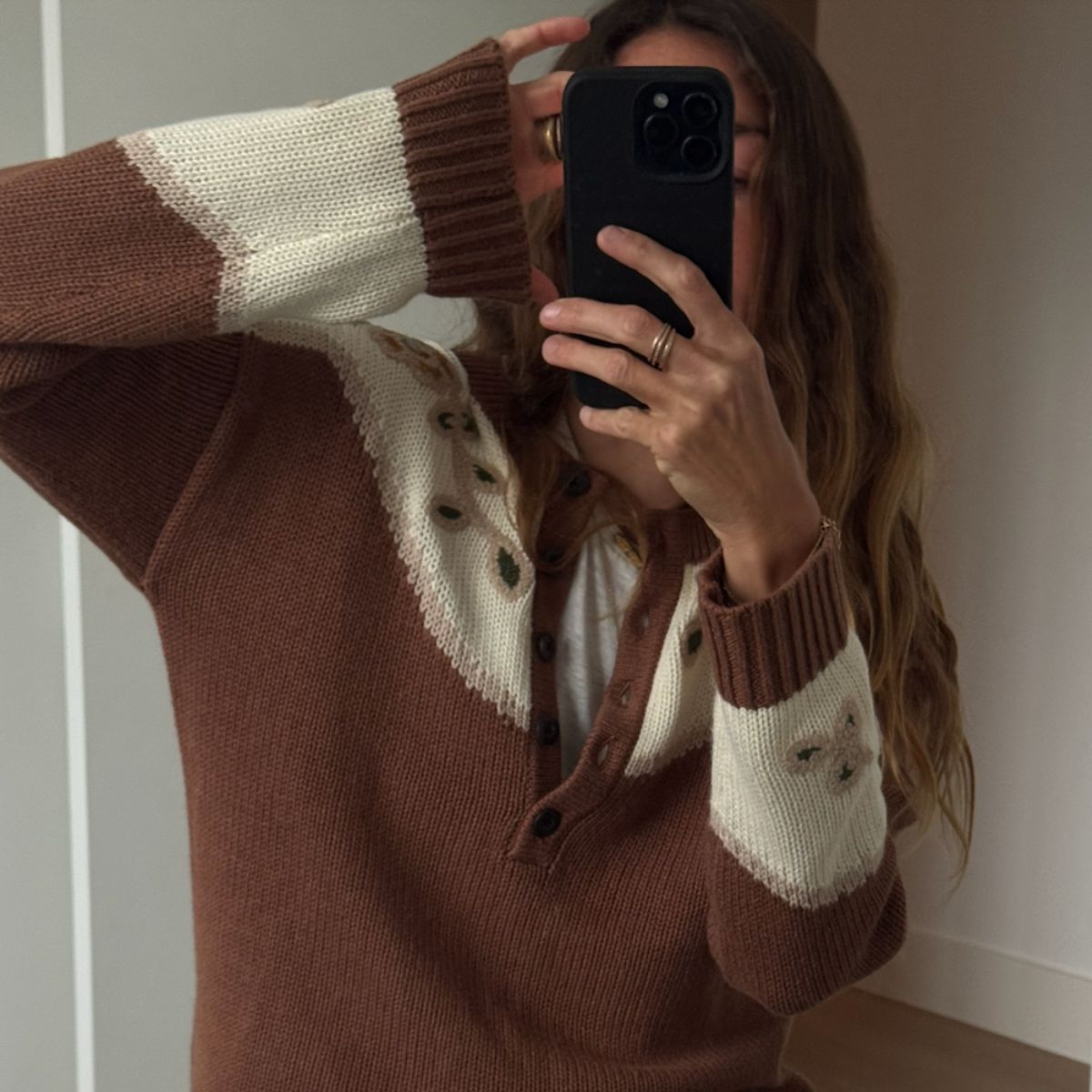 Angie wears a brow jumper