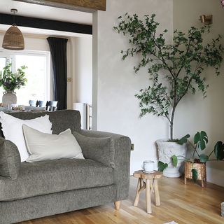 through living room with sofa and faux tree