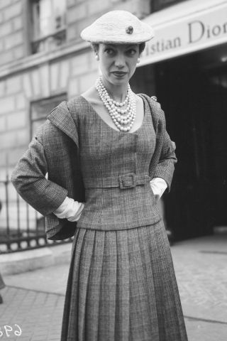 vintage photo of a woman wearing a beret with a plaid coat