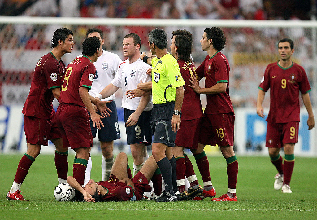 Wayne Rooney (9) argues with Portuguese midfielder Petit (2nd L) and Cristiano Ronaldo (L) after being given a red card by referee Horacio Elizendo (yellow jersey) for a foul on Ricardo Carvalho