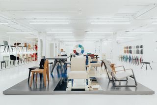 White gallery space with Jean Prouve chairs by Vitra