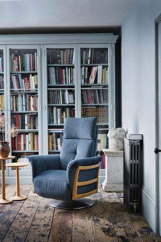 blue living room with bookshelves and blue armchair