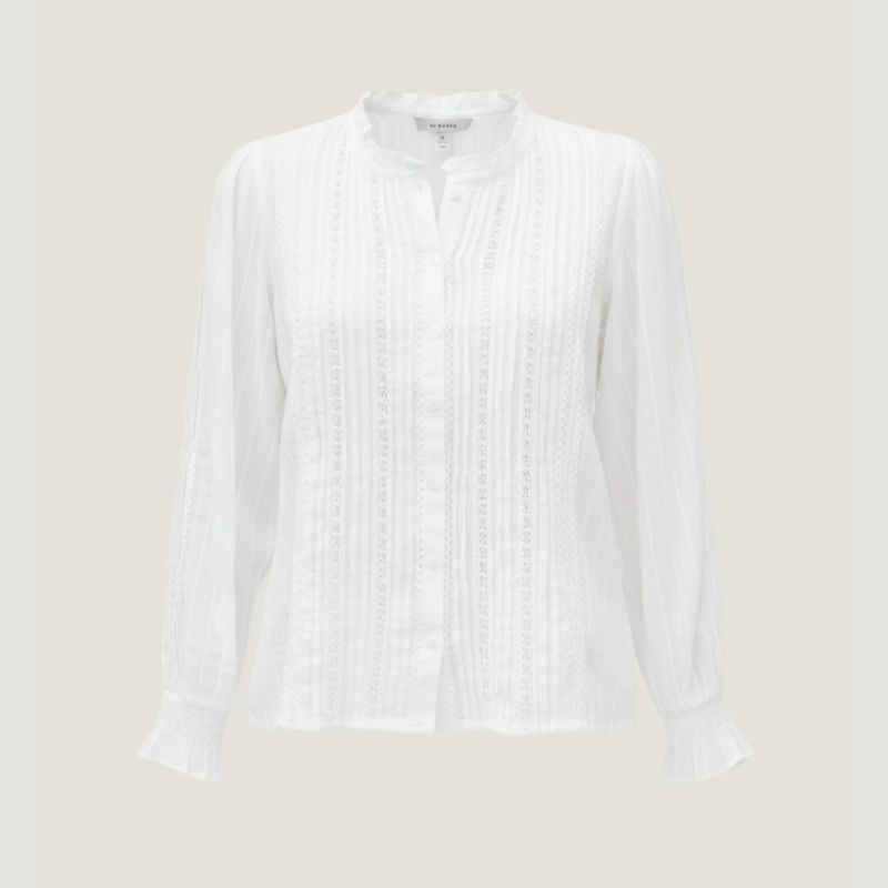 A white lace trimmed blouse by Aspiga