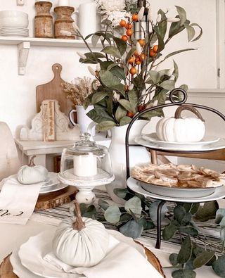 Dining table with white tablescape and white pumpkins