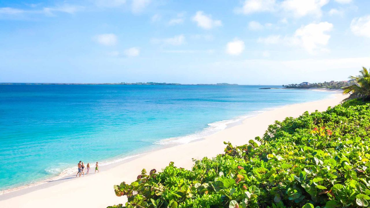 A white sandy beach and blue waters of Nassau