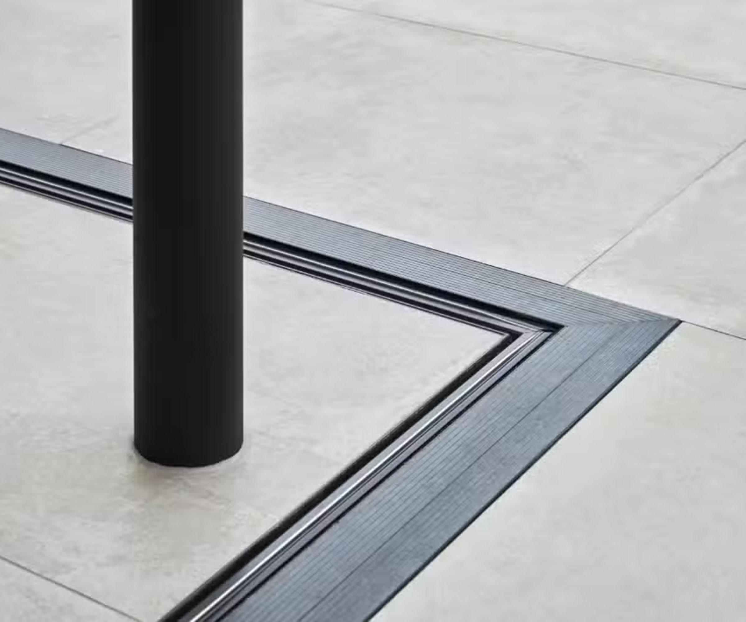 close up detail image of a flush track system in the ground for a set of corner exterior sliding doors