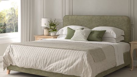 A green upholstered king sized bed with white bedding on it. In a neutral bedroom