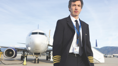 Nathan Fielder standing in front of an airplane in season two of The Rehearsal.