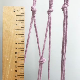 wooden scale with three purple cords