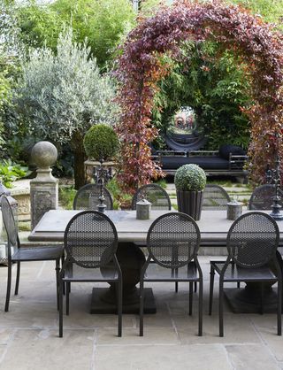 black patio chairs and a stone table