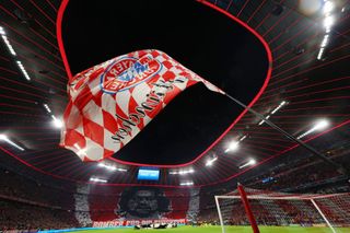 General view inside the stadium as fans display a tifo showing a picture of the deceased striker Gerd Mueller and the lettering 'Bomber fuer die Ewigkeit' prior to the UEFA Champions League Quarter Final Leg Two match between Bayern München and Villarreal CF at Football Arena Munich on April 12, 2022 in Munich, Germany.