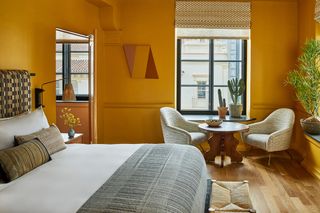 a hotel room painted in bright yellow