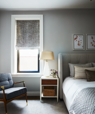 A gray bedroom with a window.