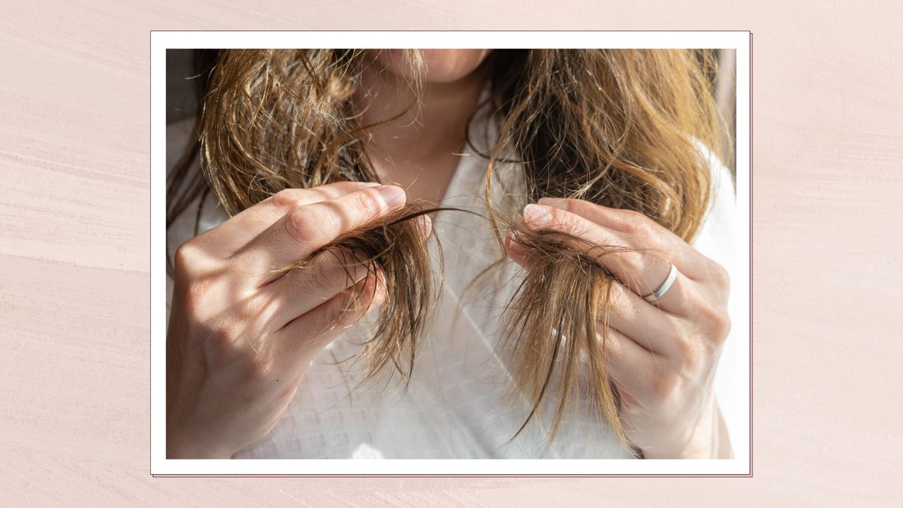 A close up of a woman holding the ends of her brown hair in her hands, whilst wearing a white dressing gown/ in a pink textured template