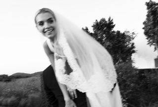 Woman in a black-and-white wedding photo.