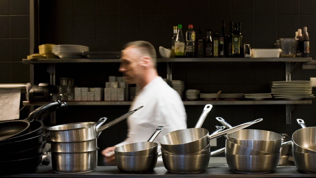 Busy chef in kitchen - stock photo