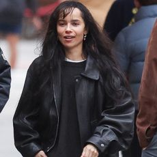 04/21/2025: Zoe Kravitz is spotted out with a male friend in New York City. The American actress wore a black leather jacket, dark brown corduroy trousers, and black boots.