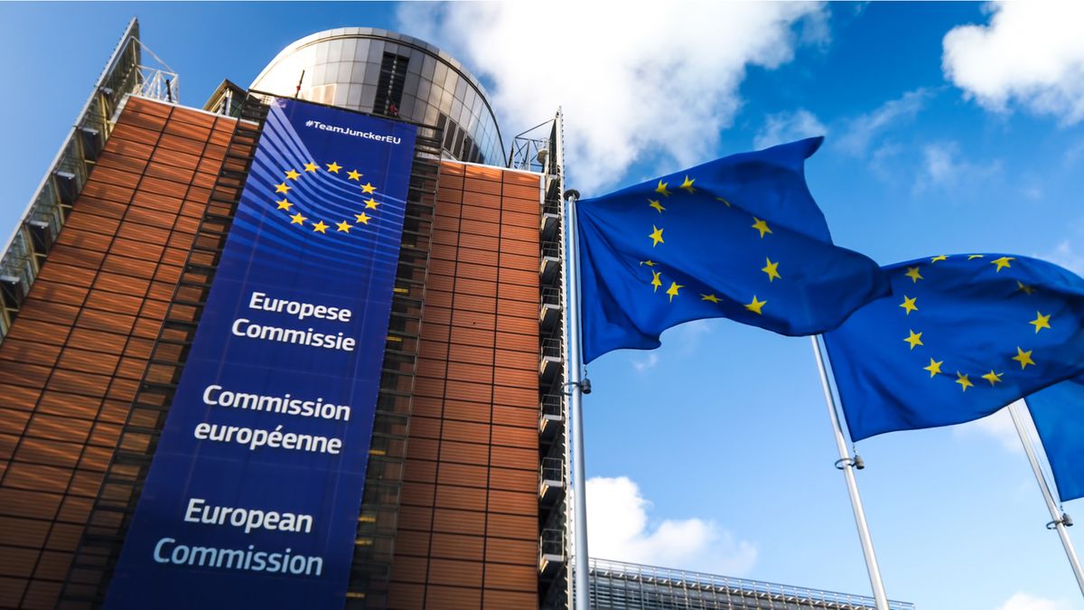 Image of the European Commission building with EU flags flying in the foreground