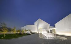 White modern building at night all lit up