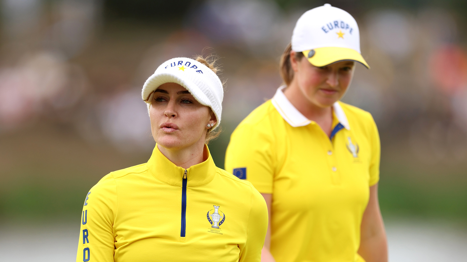Charley Hull and Lottie Woad walk off the green