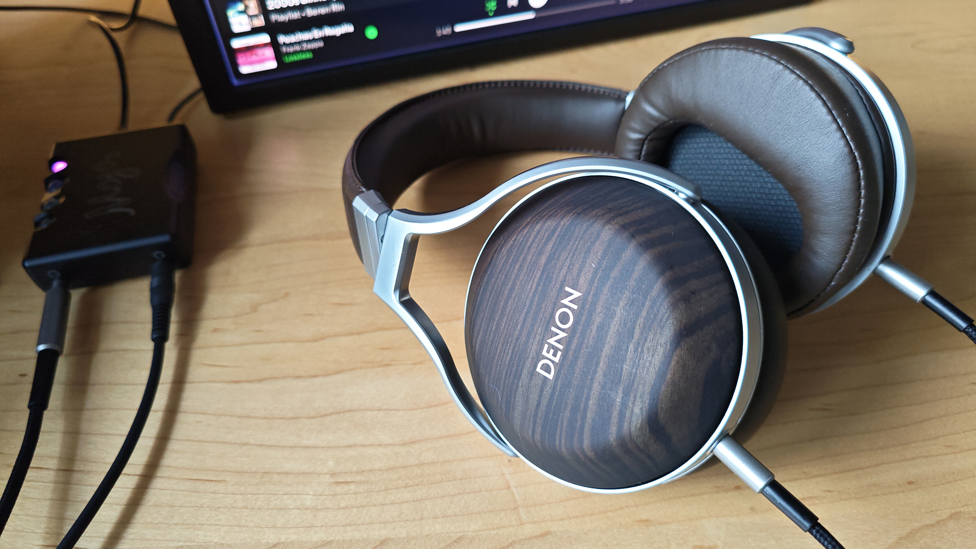 The Denon AH-D5200 and other headphones, photographed on a home desktop. 