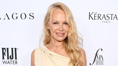 Pamela Anderson has loose blonde curls and minimal makeup as she attends The Daily Front Row Fashion Media Awards 2023 on September 08, 2023, wearing a cream one-shoulder dress