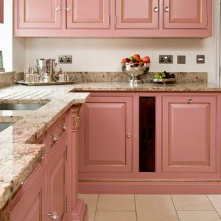 kitchen with pink cabinets brown designed counter