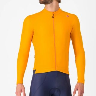 The Castelli Espresso Thermal Jersey in yellow worn by a man on a white background 