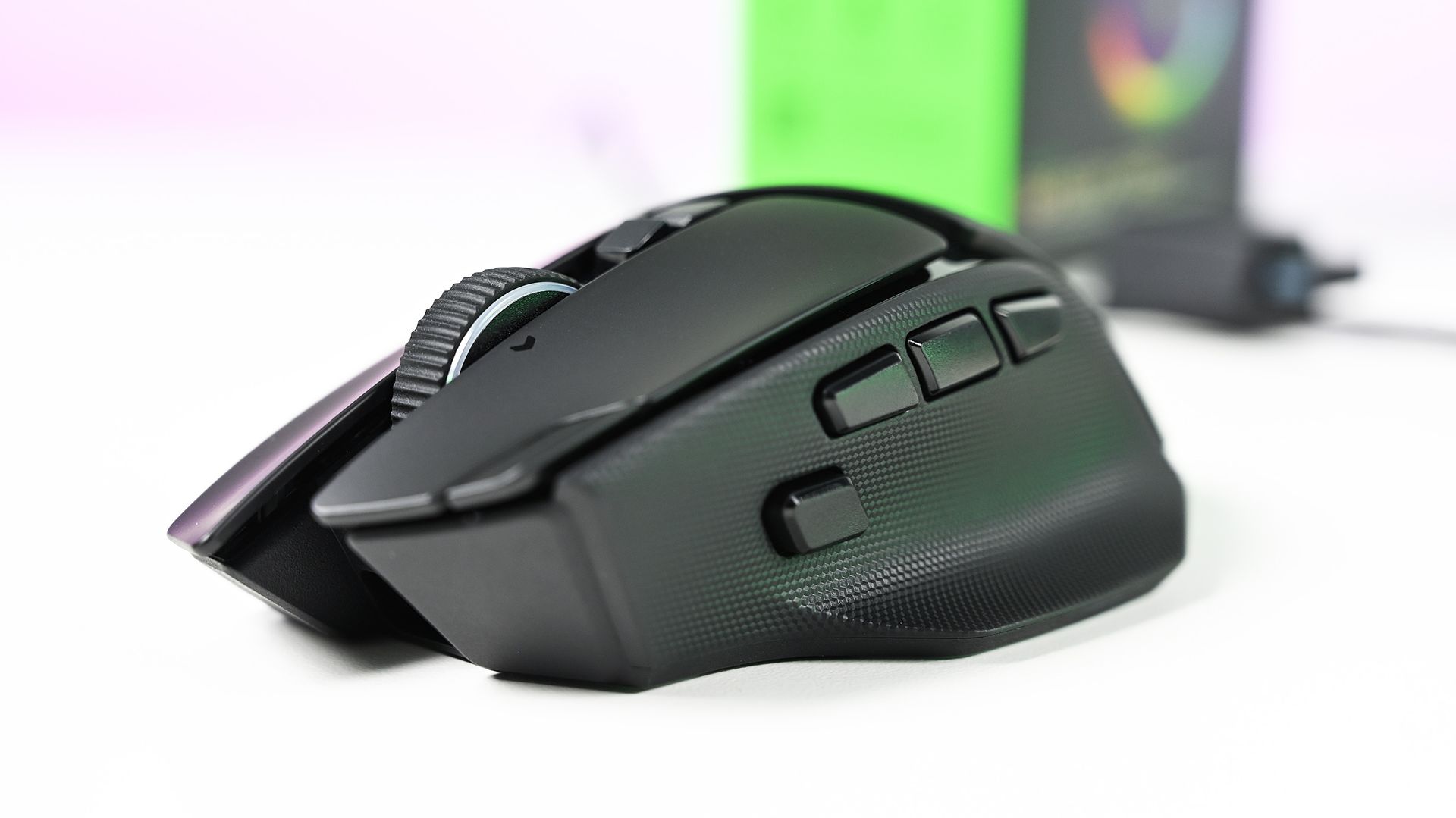 Three-quarter front view of the black Razer Basilisk V4 Pro gaming mouse showcasing the scroll wheel, left click button, side thumb paddle, and textured side grip.