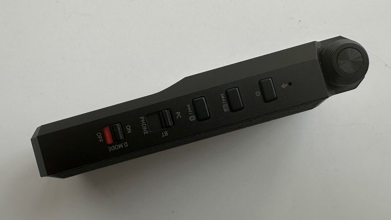 FiiO's BTR17 DAC/amp in black, on a gray table, showing PCM resolution in yellow font