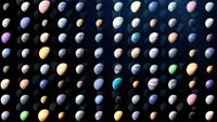 An artist's illustration of the various exoplanets found, with rows of colorful planets of all colors and sizes over a dark background