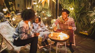 10 fall gardening tips: image of family by fire pit